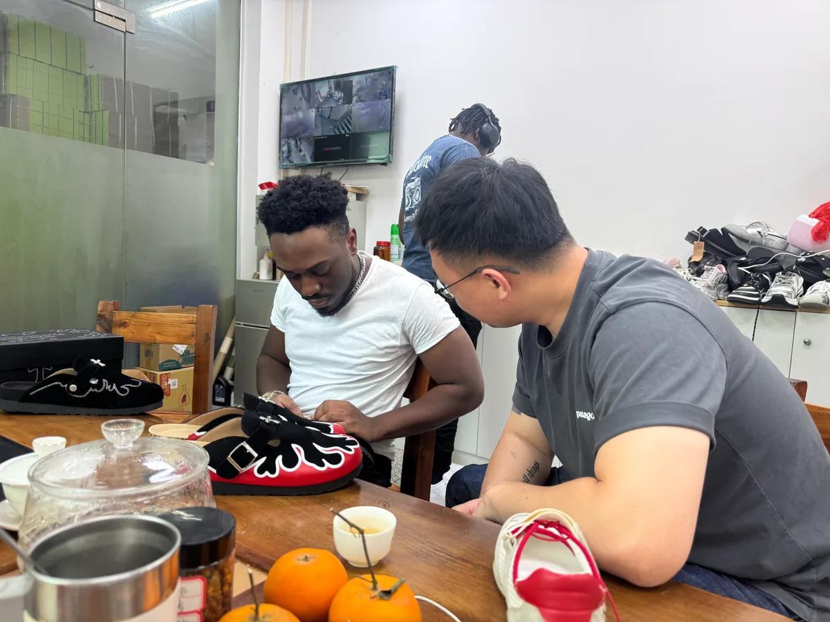 Client reviewing footwear sample details with the development team