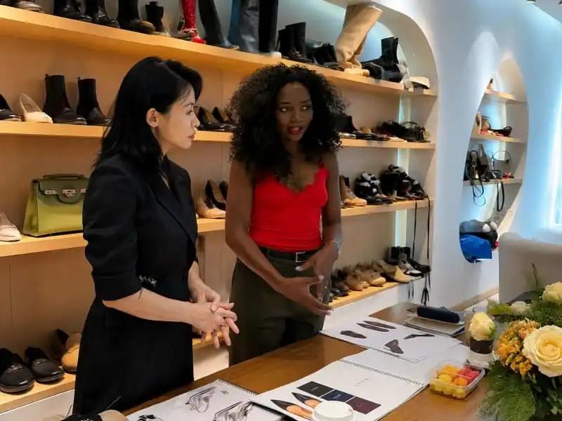 Karine Mukwe Yengo meeting with Herrains team reviewing shoe samples